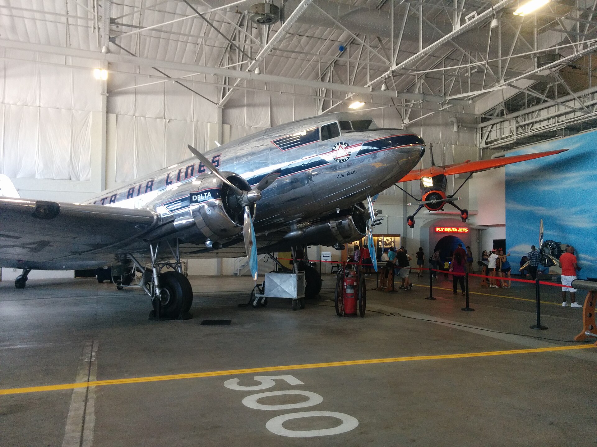 A vintage Delta Air Lines DC-3 on display inside a museum hangar