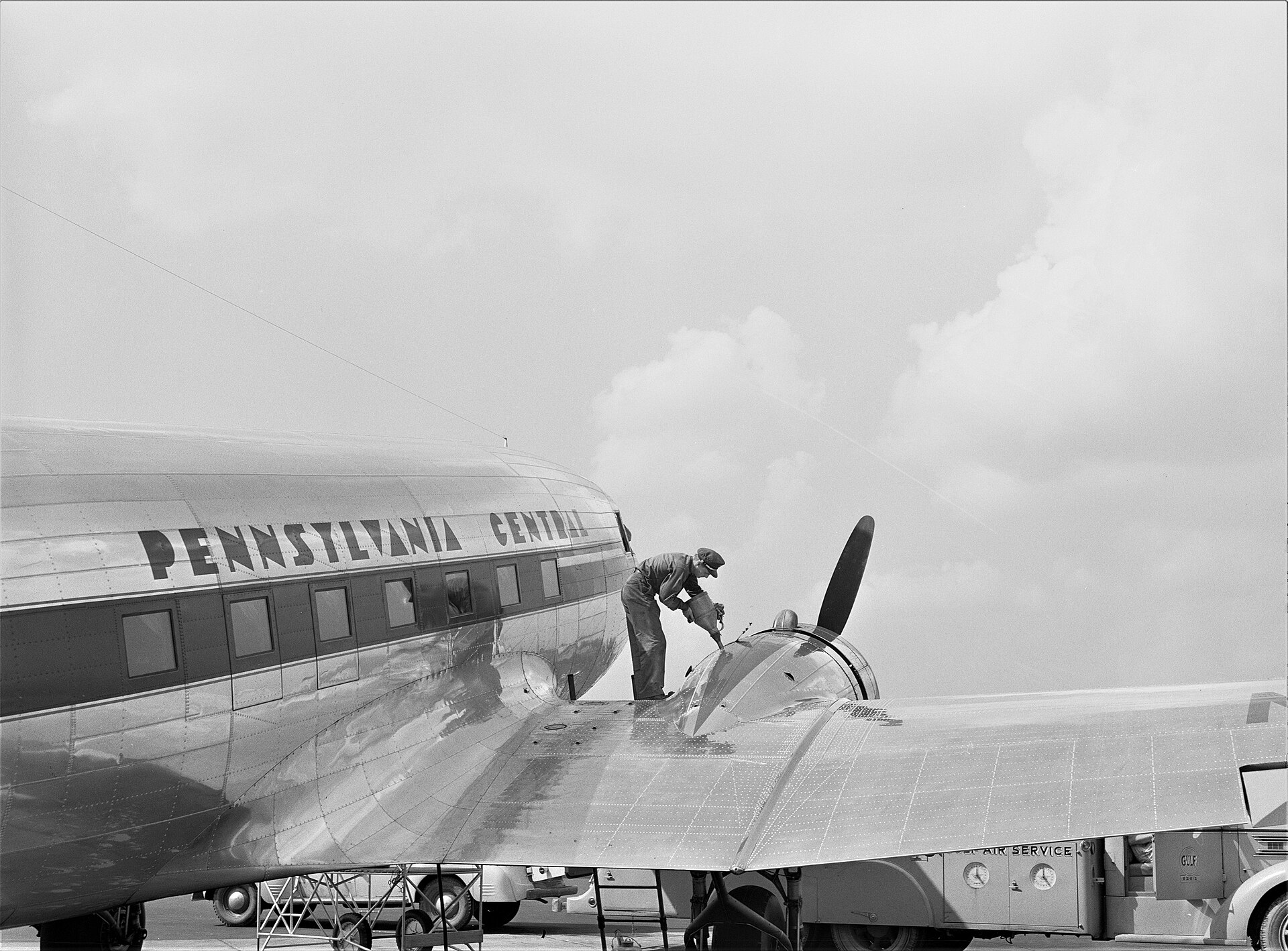A ground crewman services a Pennsylvania Central Airlines DC-3 on the tarmac, July 1941